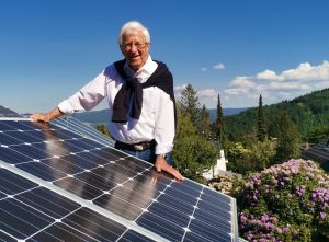 Franz Alt steht hinter einem Solarmodul